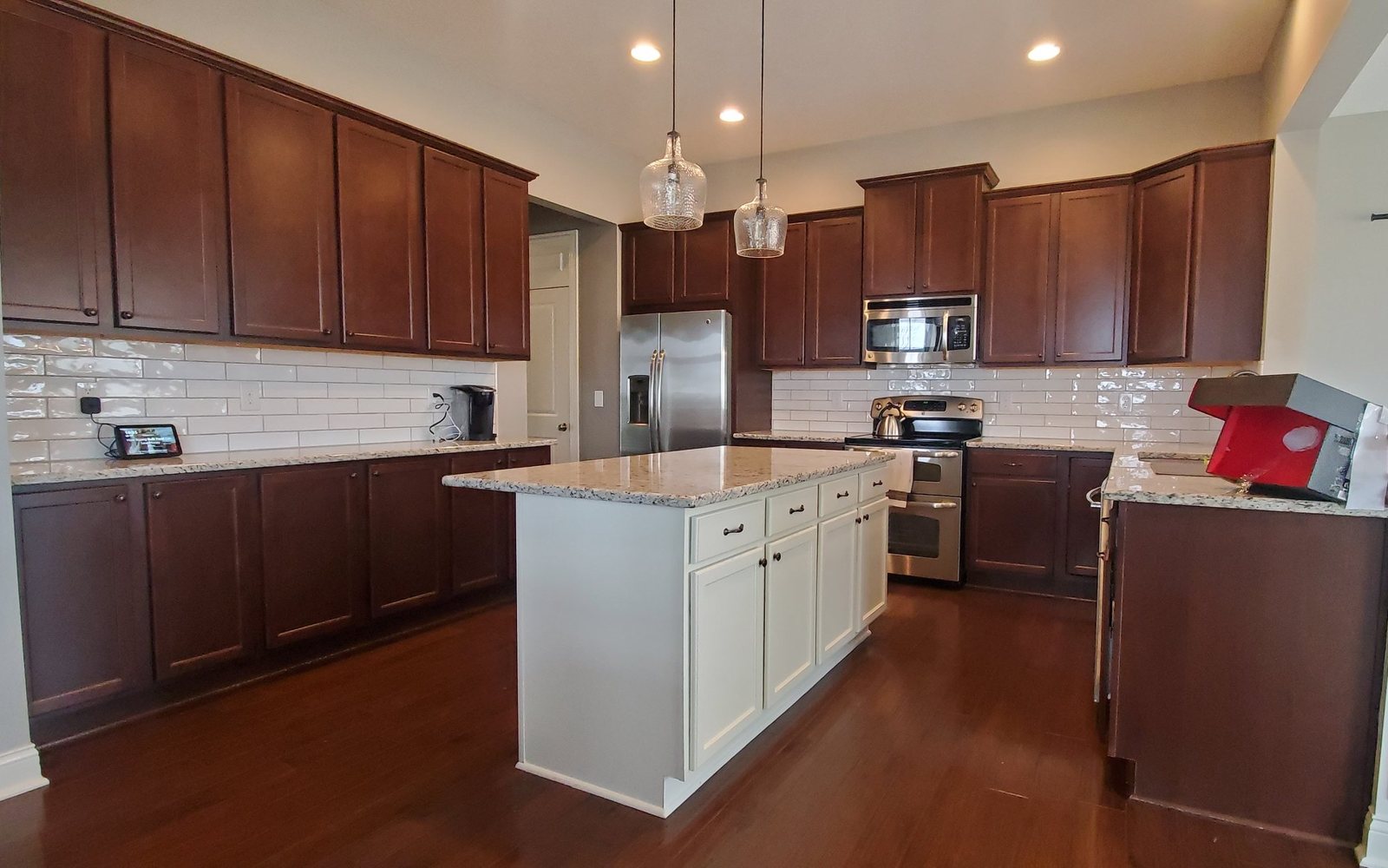 Cherry kitchen cabinets with white island before Cherry kitchen cabinets with white island before — Segor Painting, Columbus OH